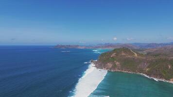 Aerial view of blue ocean and rocky coastline in Lombok, Indonesia video