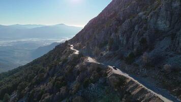 Aerial view of a winding mountain road with valley and hills video
