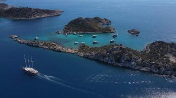 Aerial. A large yacht sails in the sea near a group of islands. video