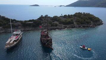 Aerial. a large ship similar to a pirate floats in the middle of the bay video
