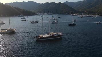 Aerial view. the yacht is in the middle of the bay along with many other boats. video