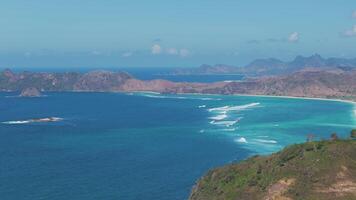 Aerial view of coastline with turquoise waters and rolling waves in Lombok video