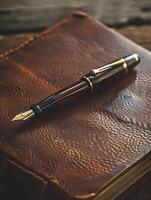 A pen and notebook on a leather book photo