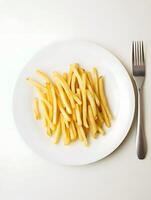 A plate with french fries and a fork photo
