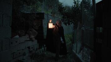 Mysterious Woman Walks Among Trees and an Abandoned House with Ghosts at Night photo