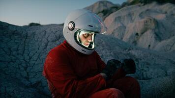 Astronaut Sits Tired On A Dry Rock At Night Before Sleeping Sad photo