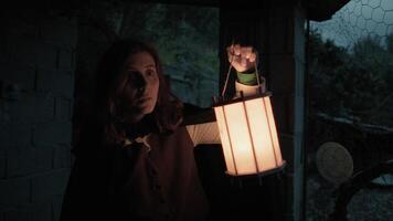 Scared Woman Explores A House In The Countryside At Night With A Lantern In Hand photo