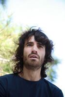 Sad Long Hair Man Is About To Cry From Depression In The Nature Park photo