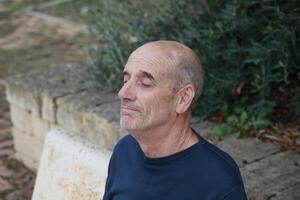 Bald Man Enjoys Rest After Work In The Countryside photo