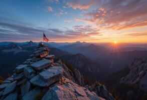 American flag atop a rock in the mountains at sunset photo
