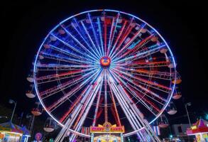 A ferris wheel at night with colorful lights photo