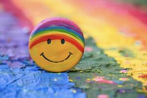 A colorful rock with a smiley face painted on it photo