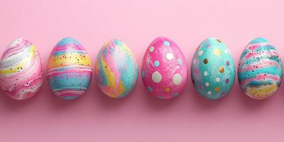 Colorful decorated easter eggs arranged on a pink background showcasing vibrant patterns and designs photo