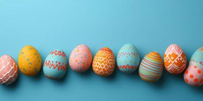 Colorful decorated eggs lined up on a bright blue background for a festive celebration or spring event photo