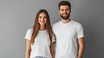 A man and woman in white t - shirts standing next to each other photo