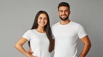 A man and woman in white t - shirts standing next to each other photo