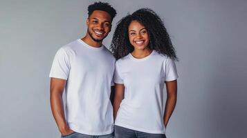 A couple in white t - shirts posing for the camera photo