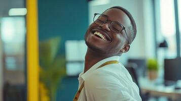 A smiling man in an office with his arms up photo