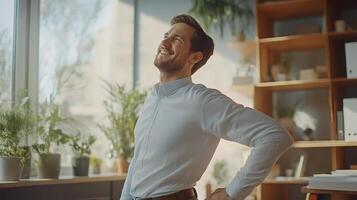 A man is standing in front of a window and smiling photo