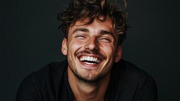 A man with curly hair and a smile photo