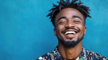 A smiling black man with dreadlocks photo
