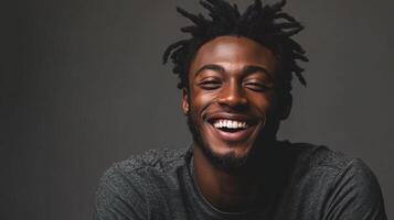 A man with dreadlocks smiling photo