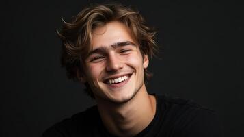 A young man with long hair smiling photo