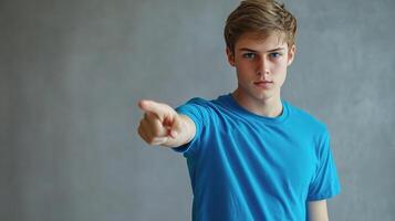 A young man pointing at something photo