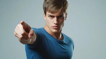 A young man pointing at something photo