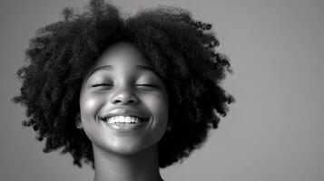A black woman with an afro smile photo