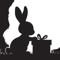 A black and white silhouette of a rabbit with a gift box vector