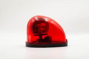 Red emergency light positioned on a plain background showcasing its design and function clearly photo