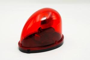 Red emergency light designed for vehicles or safety use, isolated on white background photo