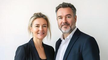 A man and woman in business attire standing next to each other photo