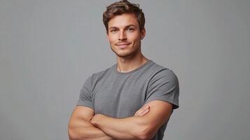 Handsome Man Smiling in Gray Shirt Standing with Confident Pose photo