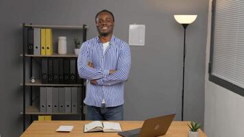 Man standing in front of desk with laptop. video