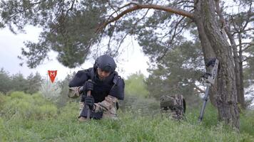 Man in a special suit works with a detector and found an explosive device. A man tries to neutralize high-explosive anti-personnel pressure mine video