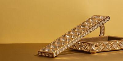 A balance beam designed with clear, sparkling crystal, etched with elegant gold patterns. photo