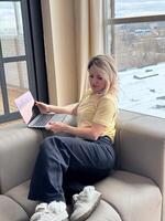 Remote Work. Smiling Young Female Using Laptop While Sitting At Home, Millennial Woman Working Or Study Remotely On Computer, Enjoying Distance Learning Or Online Job, Copy Space photo