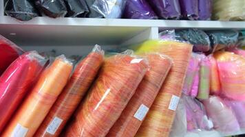 A shelf full of colorful yarns in a store video
