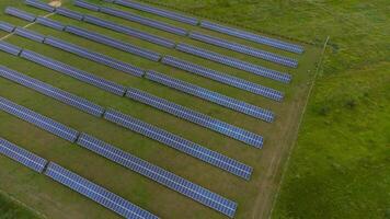 Aerial view of Solar Panels Farm solar cell with sunlight. Drone flight over solar panels field, renewable green alternative energy concept. photo