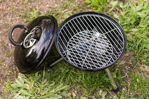 Empty Barbecue Grill Close-up In The Backyard Lawn At Summer. photo