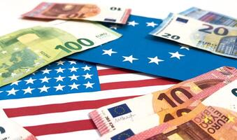 Concept of currency trading. Hundred us dollar bills lying . Fan shaped euro hundred bills.Hologram shining. Currency us euro rate chart under the bills.US flag. photo