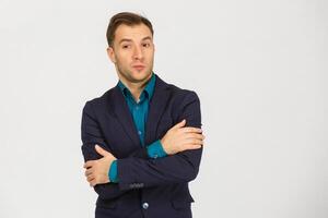 Young man having doubts and with confuse face expression while scratching head on isolated white background photo