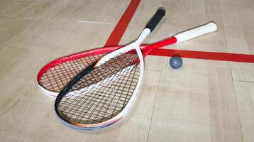 Sports, above and racket on squash court for competition, challenge and training center. Exercise, interior and empty room with top view of wooden floor of gymnasium for games, fitness club and gear photo