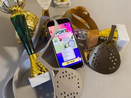 Win on sports betting, online bookmaker service. golden trophy cup, mobile phone. Banner design photo
