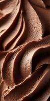 Creamy and rich chocolate frosting is expertly piped, showcasing a smooth texture and bright sheen. Perfect for decorating cakes and desserts. photo