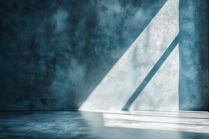 Sunlight through window casting shadows on blue textured wall surface photo