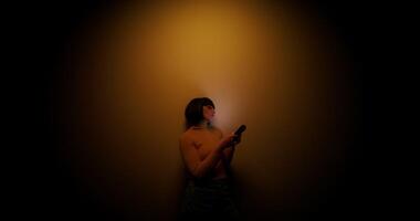 A woman uses a mobile phone in the studio video