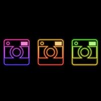 Camera. Glowing neon icon on brick wall background vector